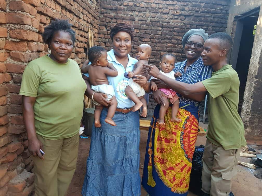 Three women and one man with babies