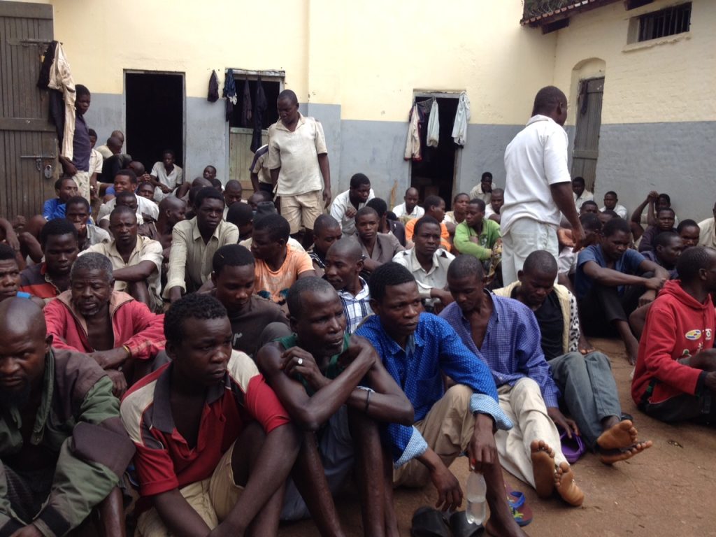 Group of men seated on the ground