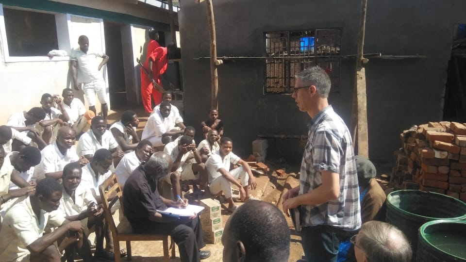 Joel speaking with group of men